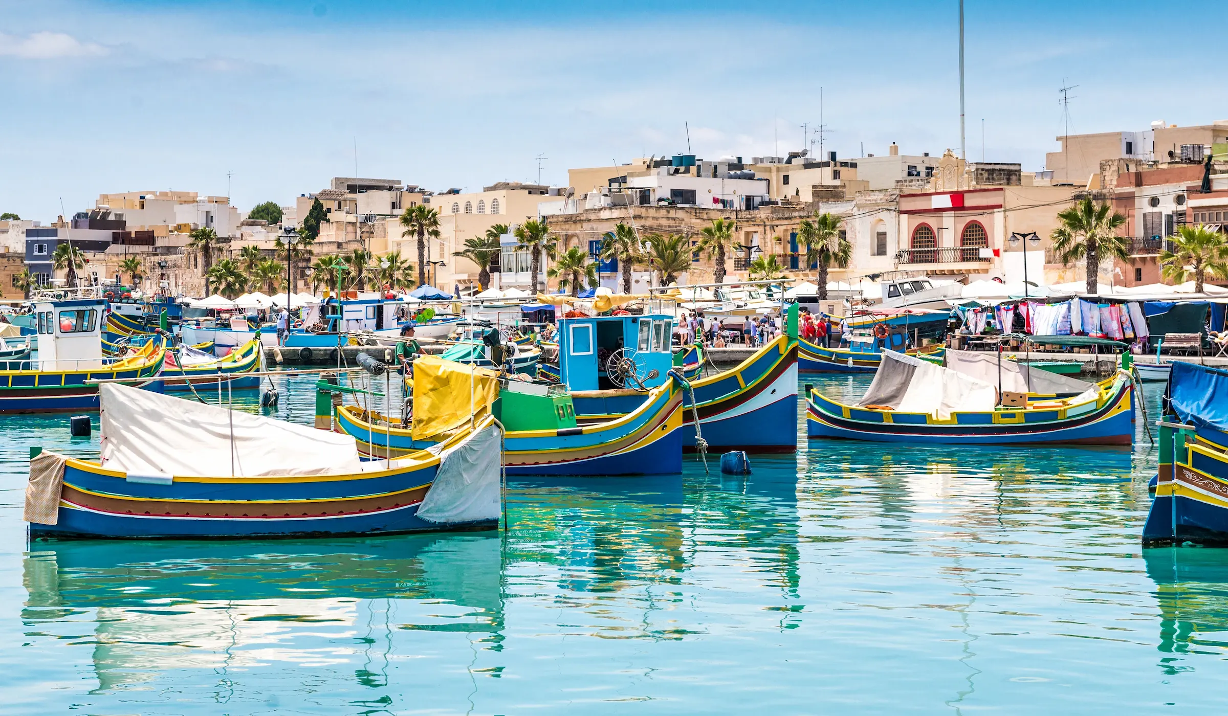 Image of local, colourful boats on the water in a Tunisian harbour