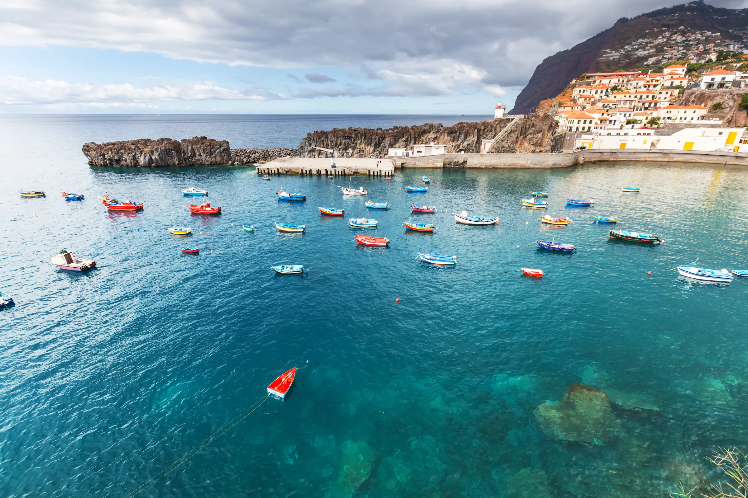 Portuguese coastal town Madeira with colourful boats — luxury Portugal travel with Eventra Bespoke