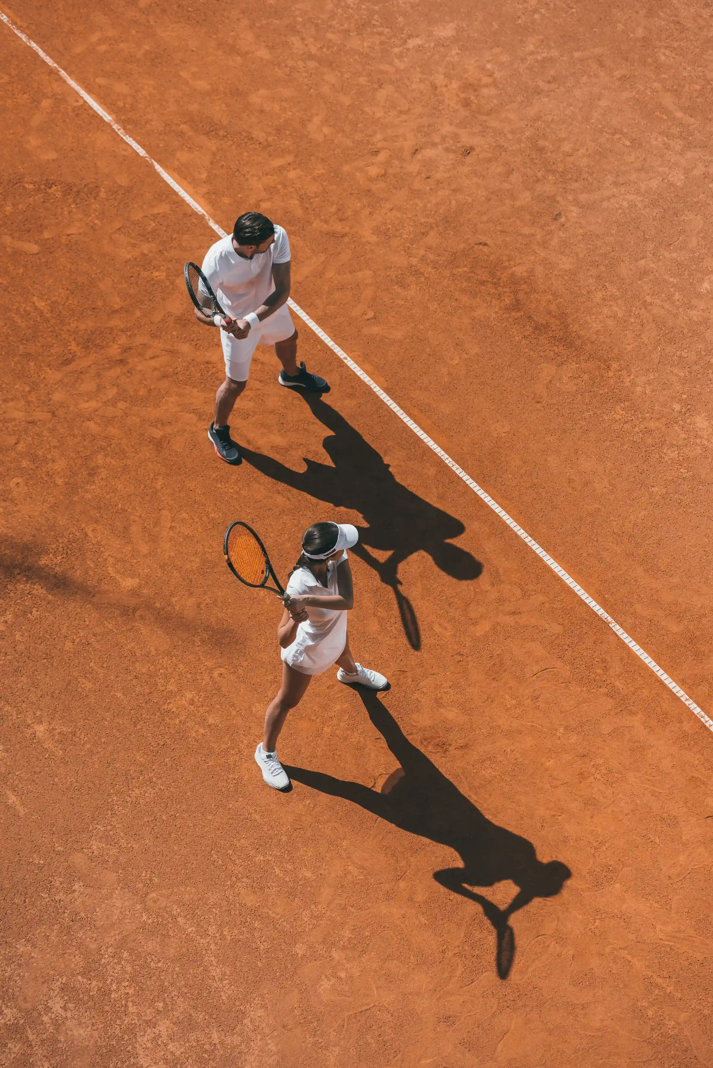 Aerial view of two tennis players on a clay court